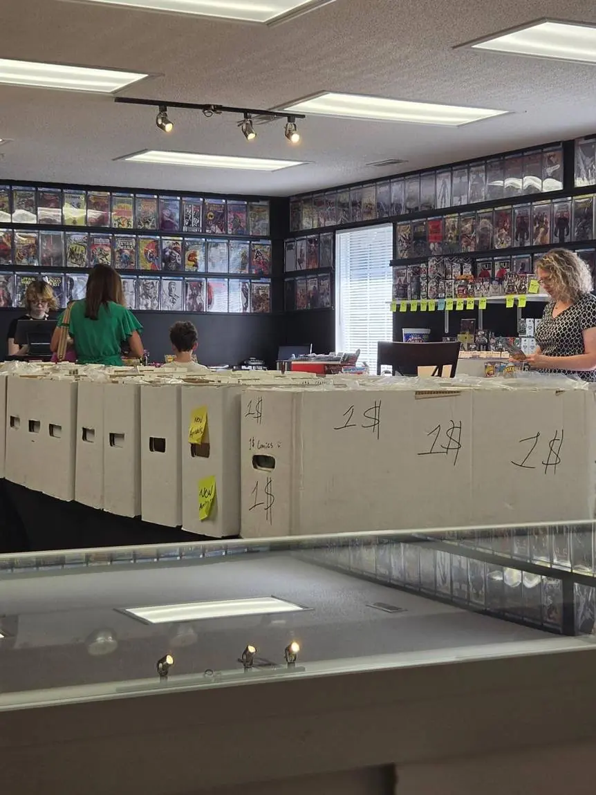 Customers digging through the $1 and up comic boxes