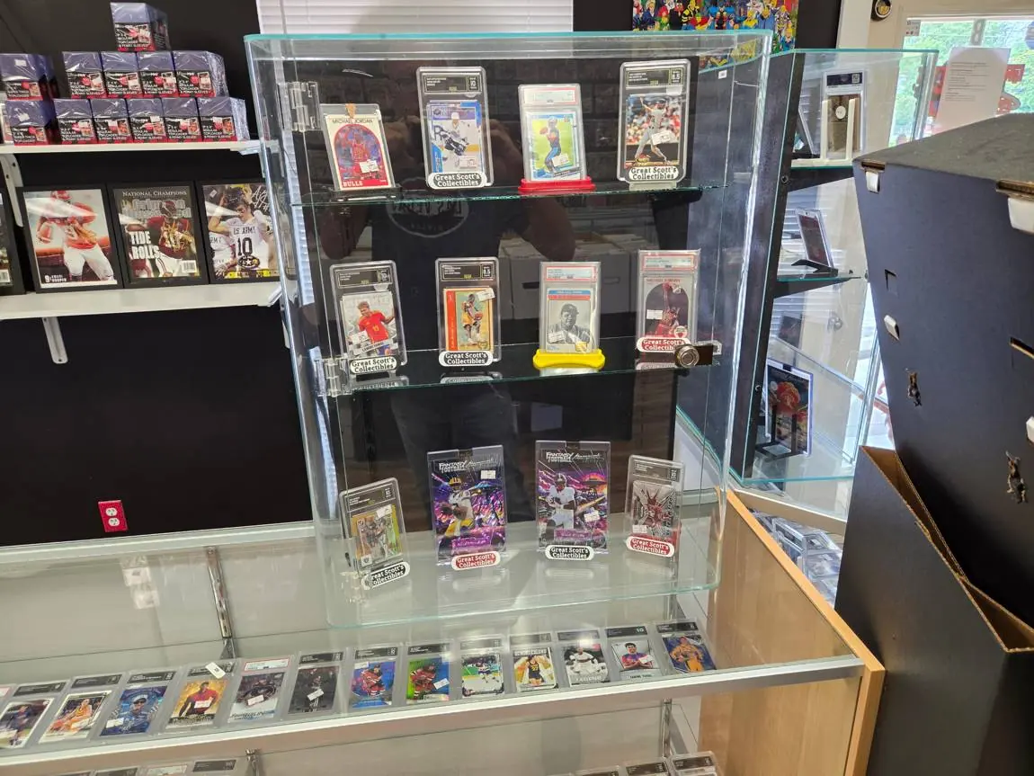 Display case of graded Michael Jordan, Babe Ruth and football cards
