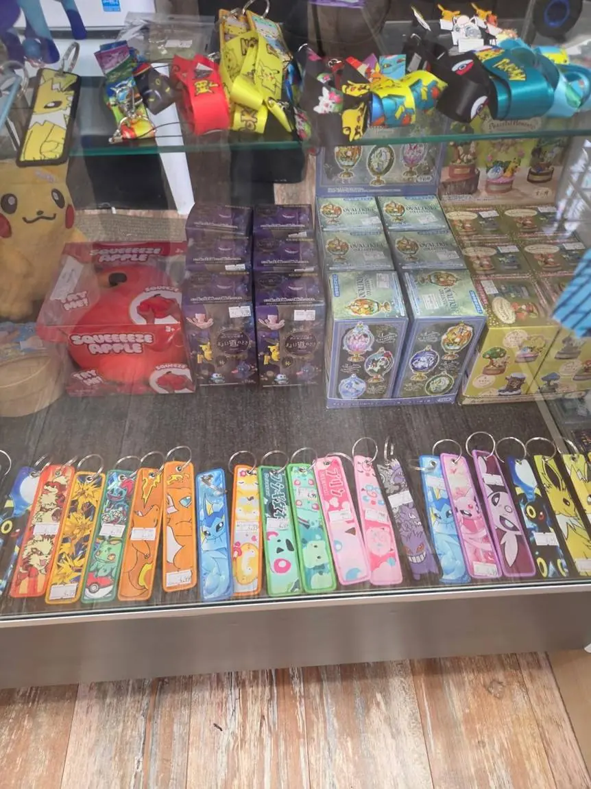 Pokémon plush, booster boxes and keychains in the display case