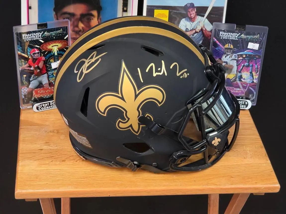 Signed New Orleans Saints mini helmet with graded football cards