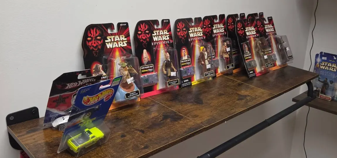 Shelf of carded Star Wars Episode I figures with Yoda, Ki-Adi-Mundi and Obi-Wan Kenobi