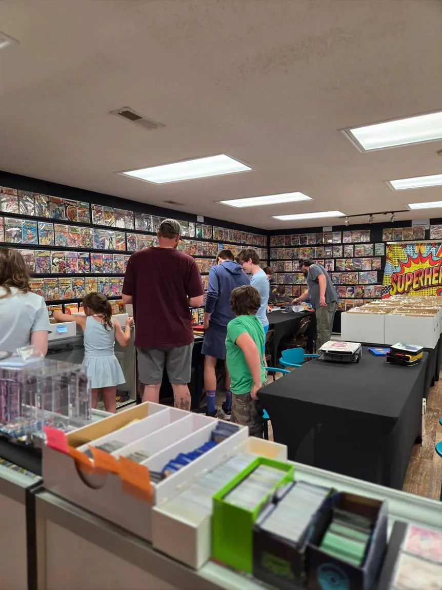 Families browsing the comic wall and card tables on Trade Night